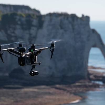 Flying UAV Inspire 2 for tourism, institutional and corporate filming, in front of the cliffs of Etretat, Hauts-de-France